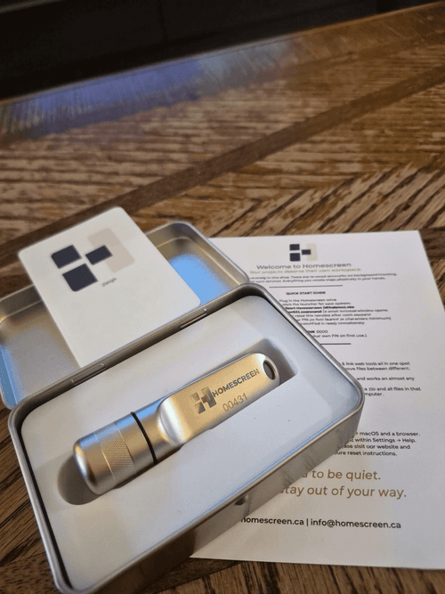 128GB portable USB drive with workspace displayed inside a metal case with a welcome note.